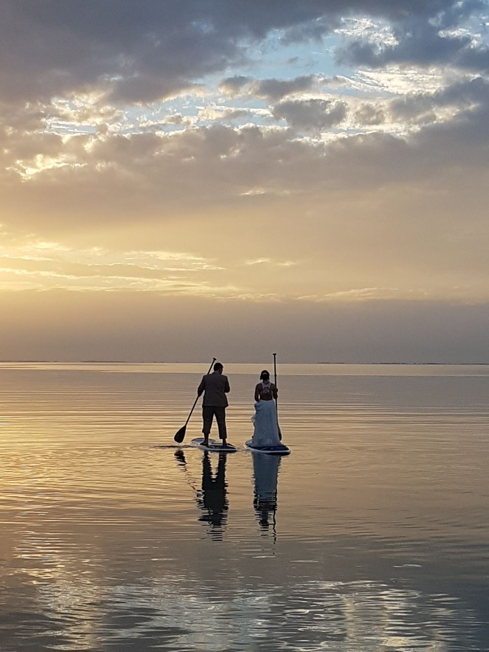 Wedded-Bliss-on-SUPs-at-sunset-St-Georges-Caye-Belize