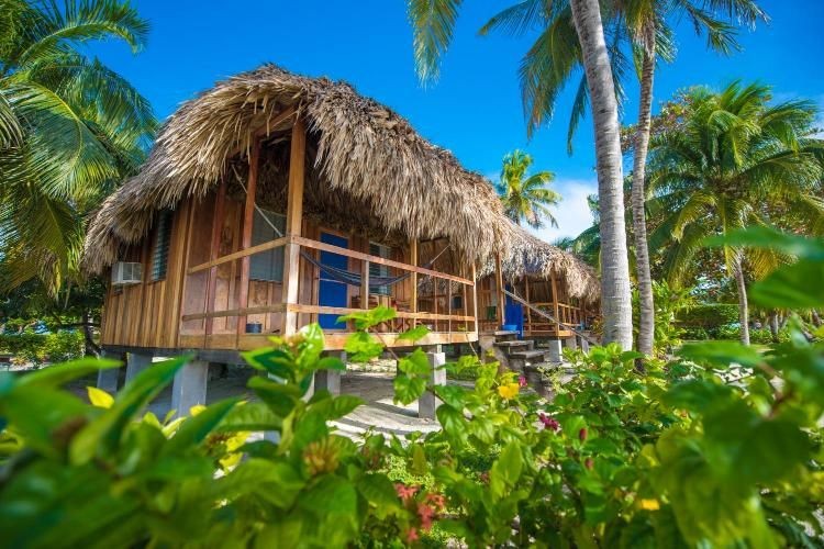 st-george-s-caye-resort-over-water-thatched-roof-cabana-ocean-front